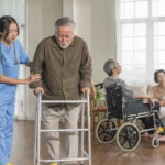 young asian female nurse care giver helping asian senior old man with mobility walker in living area of nursing home senior daycare center,Nurse take care elderly patient with cheerful concentrate